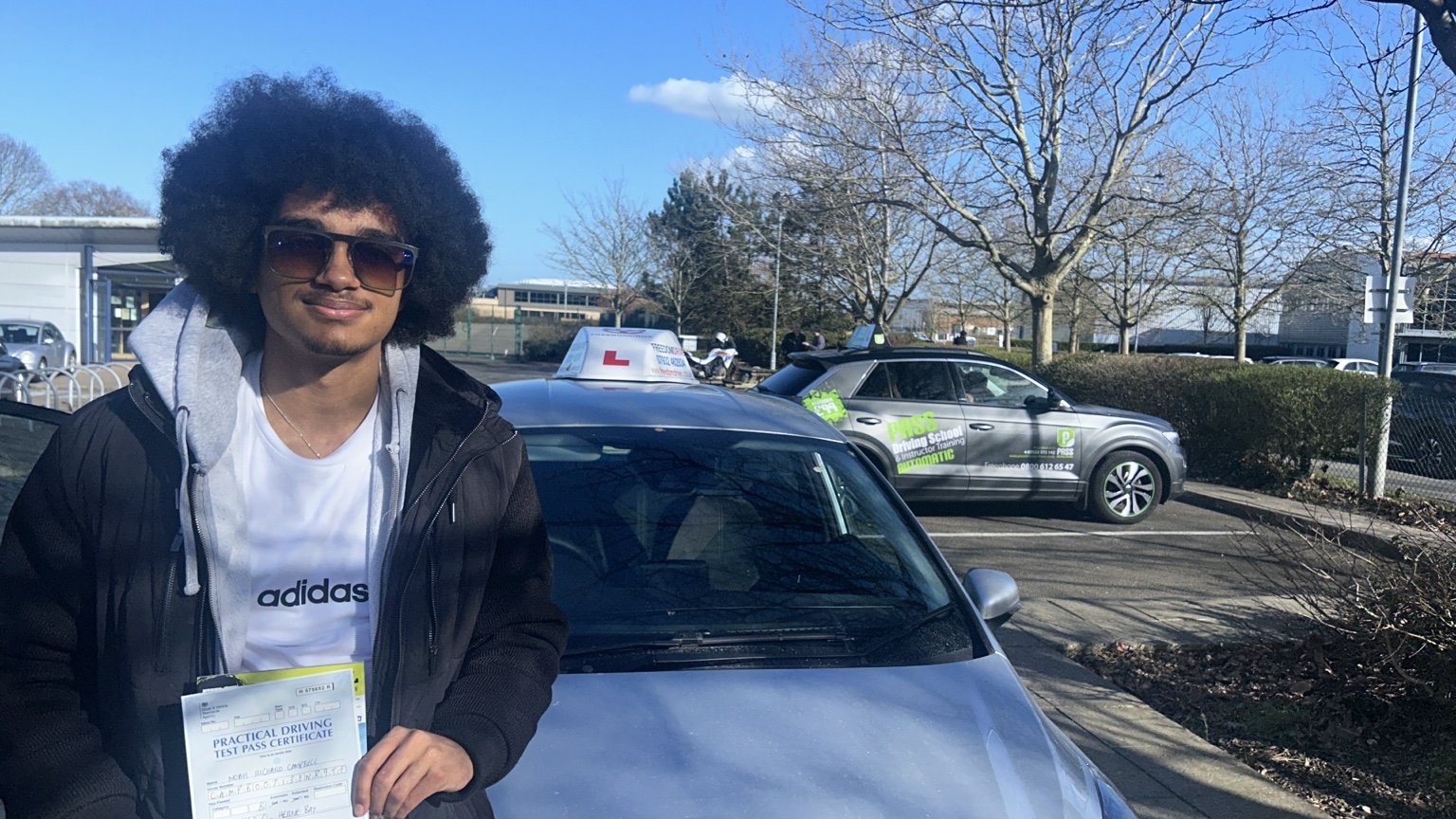 Noah Campbell holding a driving test pass certificate