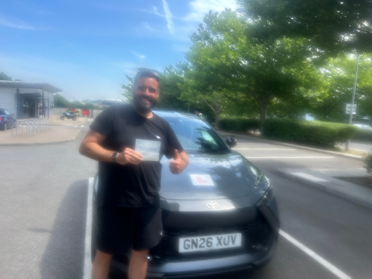 Luke Brown holding a driving test pass certificate